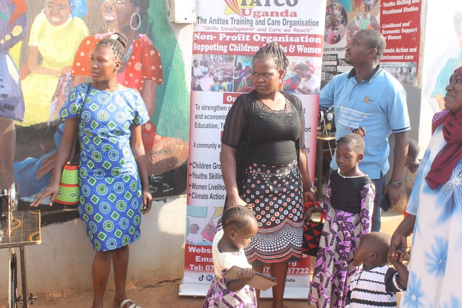 TATCO Uganda community banner and staff at a community event